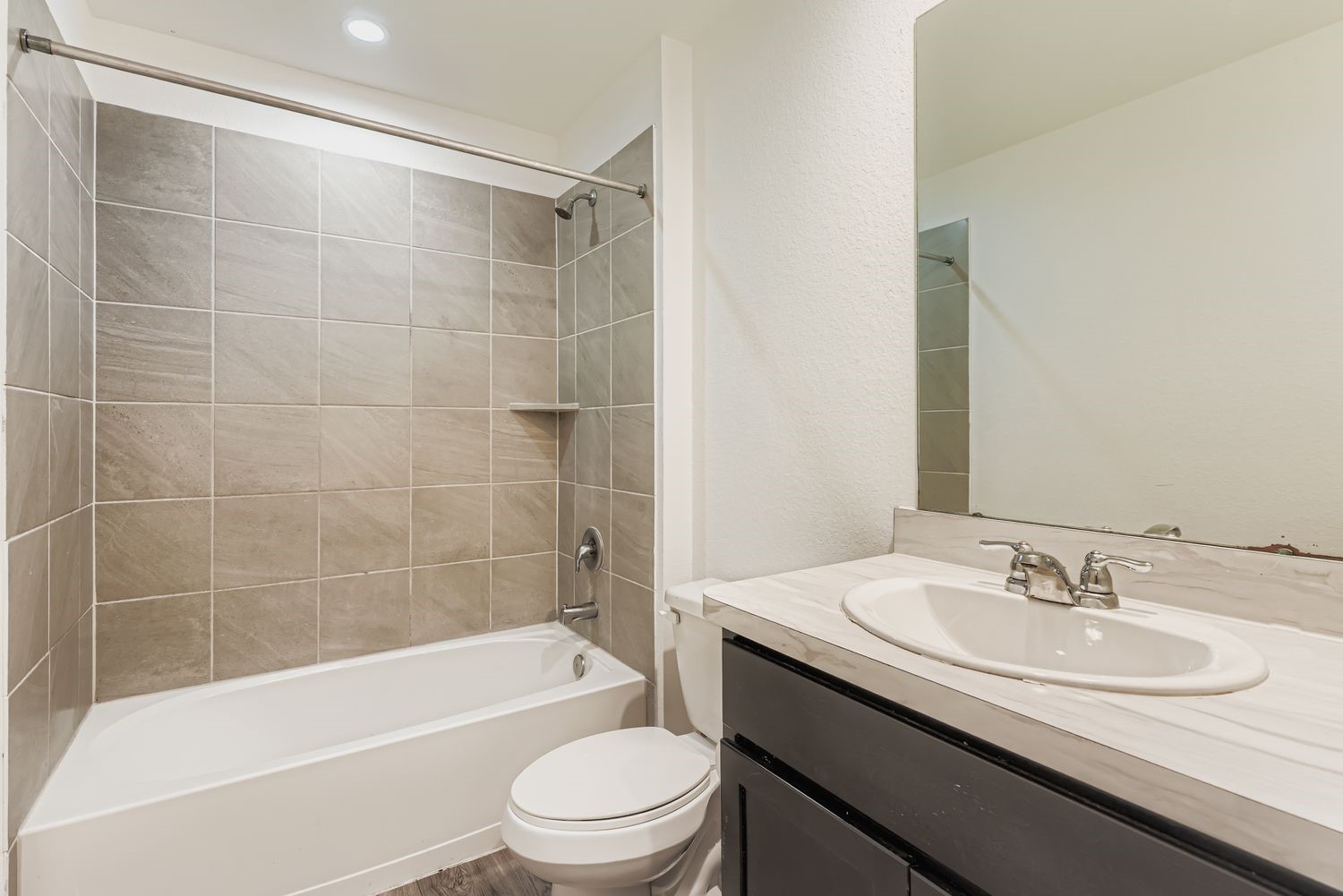 1726 Windstone Ridge Drive Houston, TX 77014 - Photo 21 of 28 a bathroom with a granite countertop sink a toilet a mirror a bathtub and shower