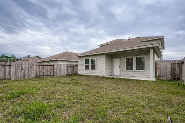 a view of a backyard with wooden fence