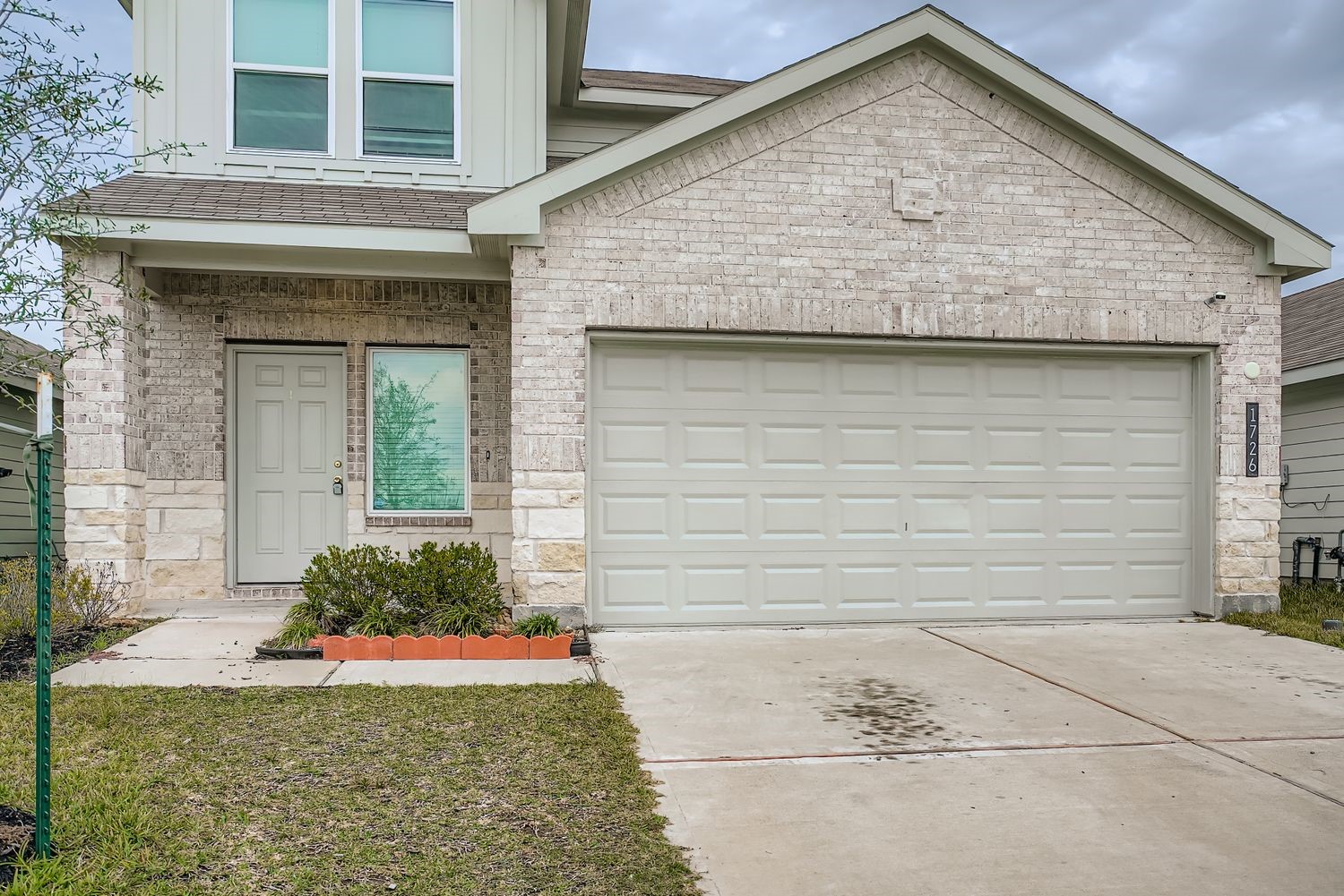 1726 Windstone Ridge Drive Houston, TX 77014 - Photo 3 of 28 a front view of a house with garden