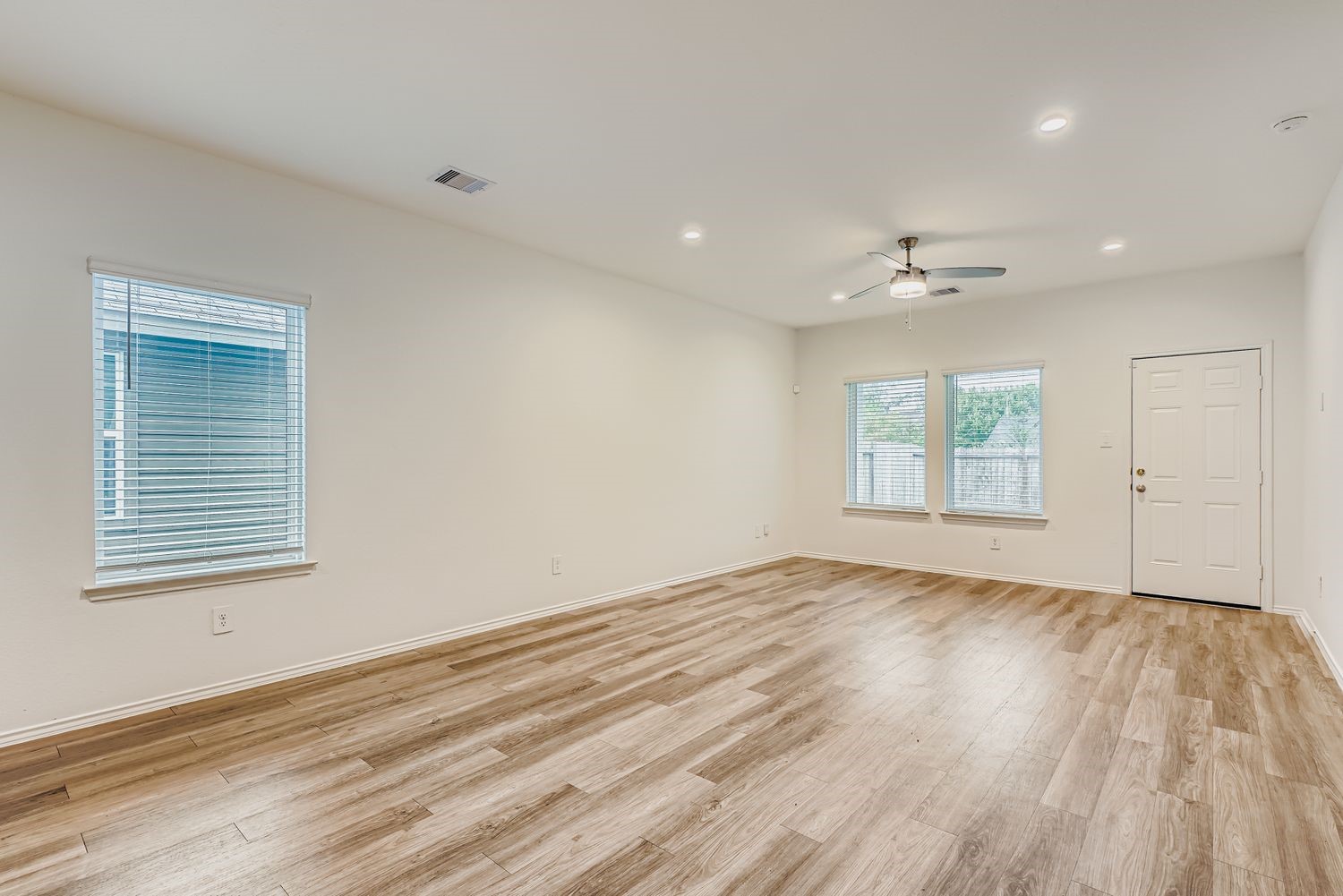 1726 Windstone Ridge Drive Houston, TX 77014 - Photo 5 of 28 a view of an empty room with wooden floor and a window