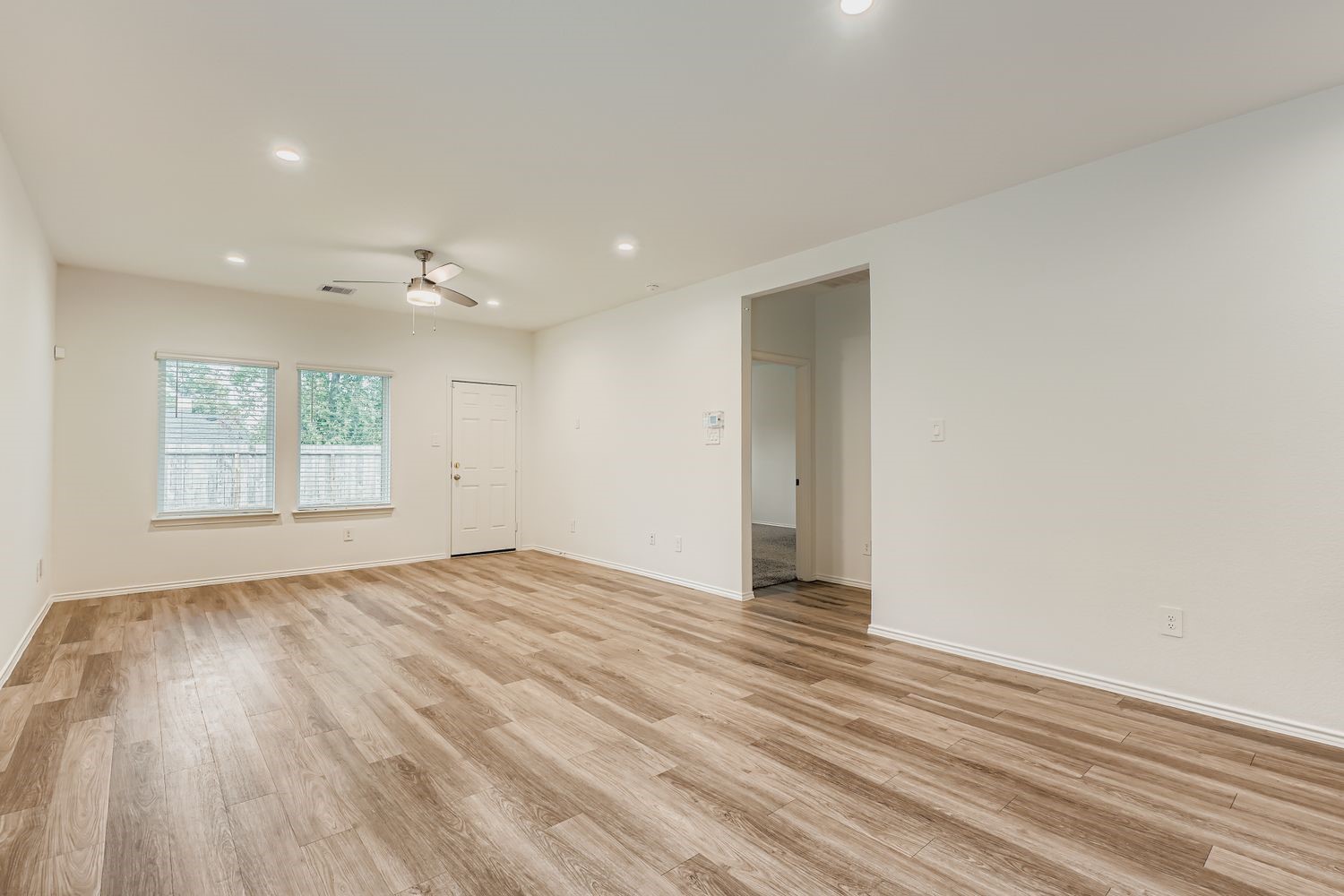 1726 Windstone Ridge Drive Houston, TX 77014 - Photo 6 of 28 a view of an empty room with wooden floor and a window