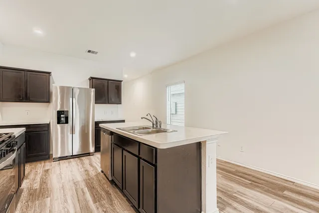 a kitchen with stainless steel appliances granite countertop a sink stove and microwave