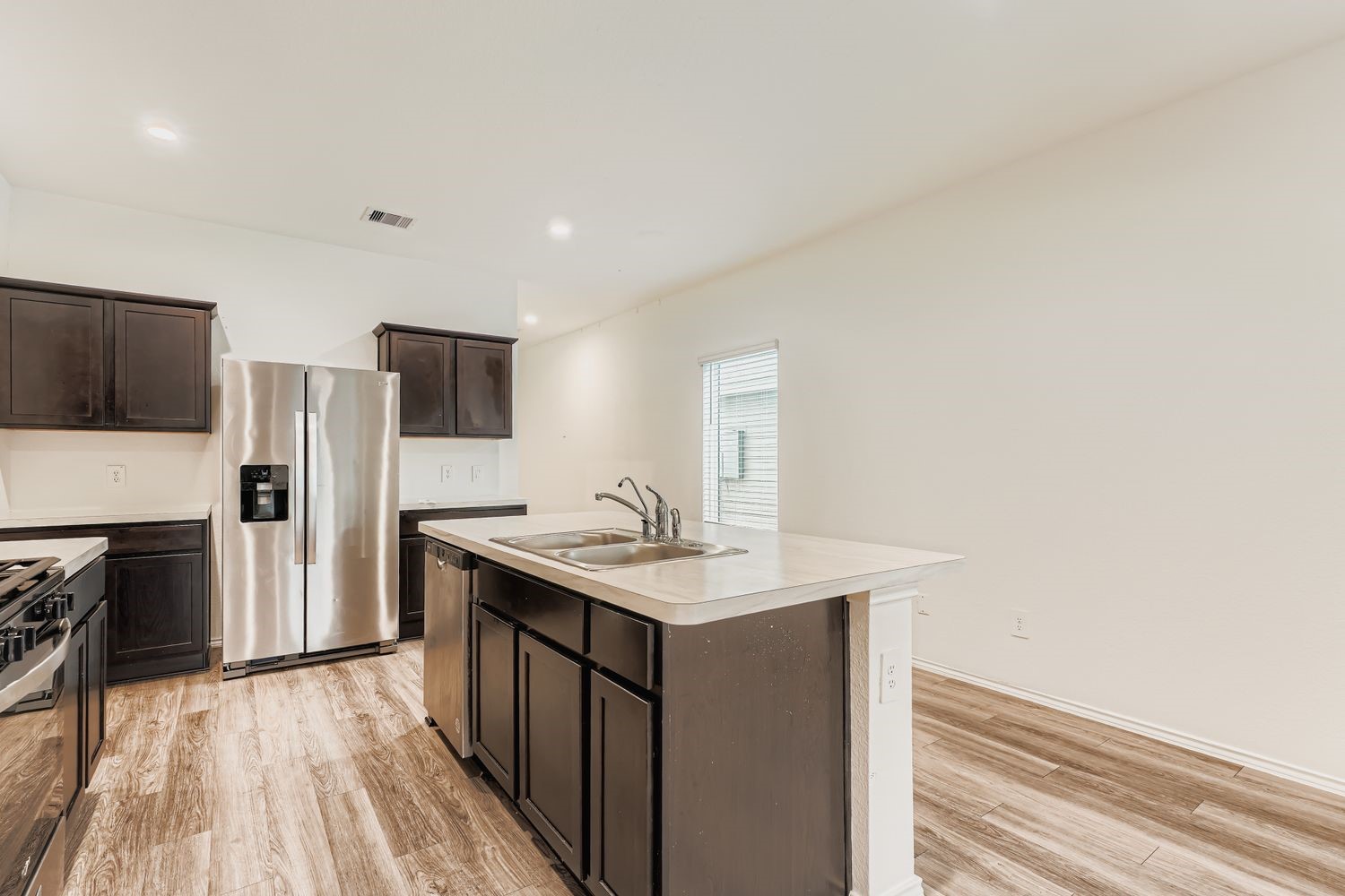 1726 Windstone Ridge Drive Houston, TX 77014 - Photo 8 of 28 a kitchen with stainless steel appliances granite countertop a sink stove and refrigerator