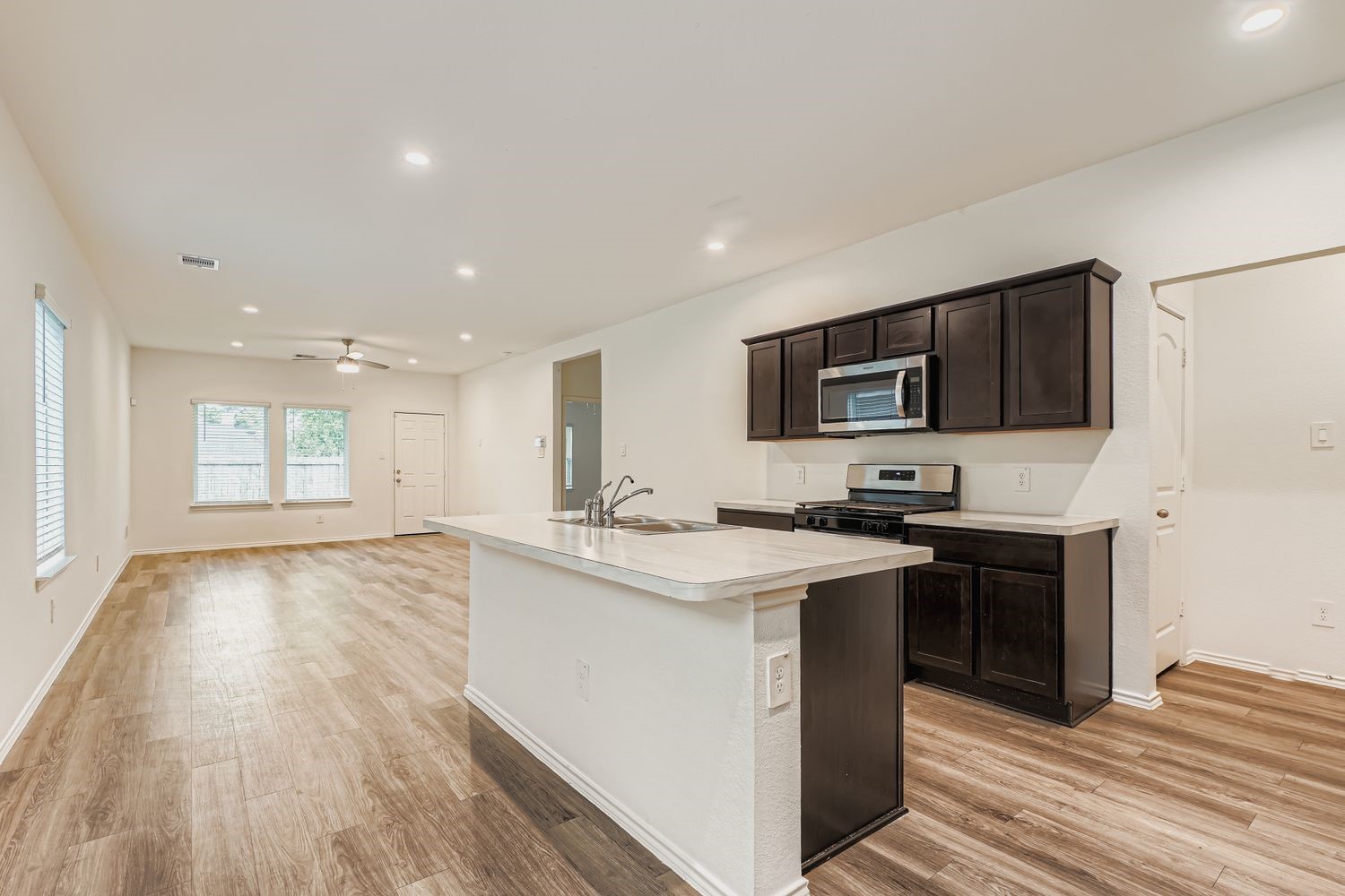 1726 Windstone Ridge Drive Houston, TX 77014 - Photo 9 of 28 a kitchen with stainless steel appliances granite countertop a sink stove and microwave
