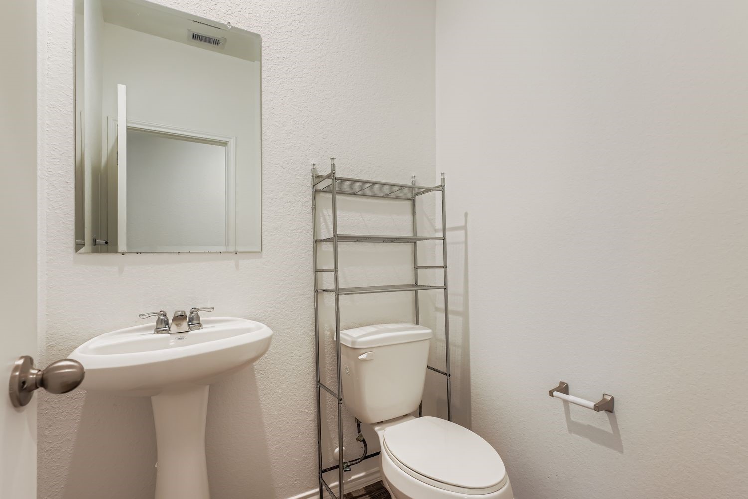 1726 Windstone Ridge Drive Houston, TX 77014 - Photo 10 of 28 a bathroom with a toilet sink and mirror