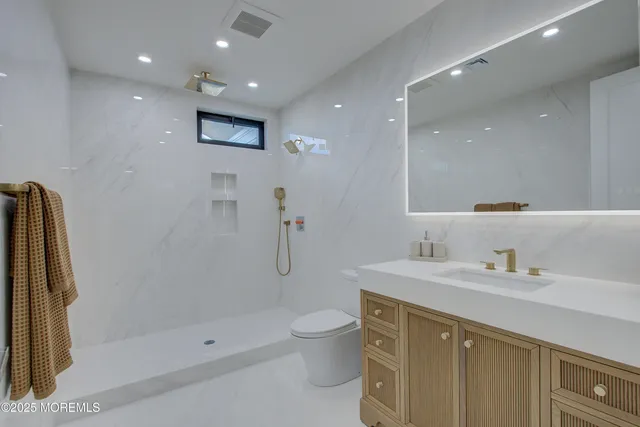 a bathroom with a toilet sink and shower