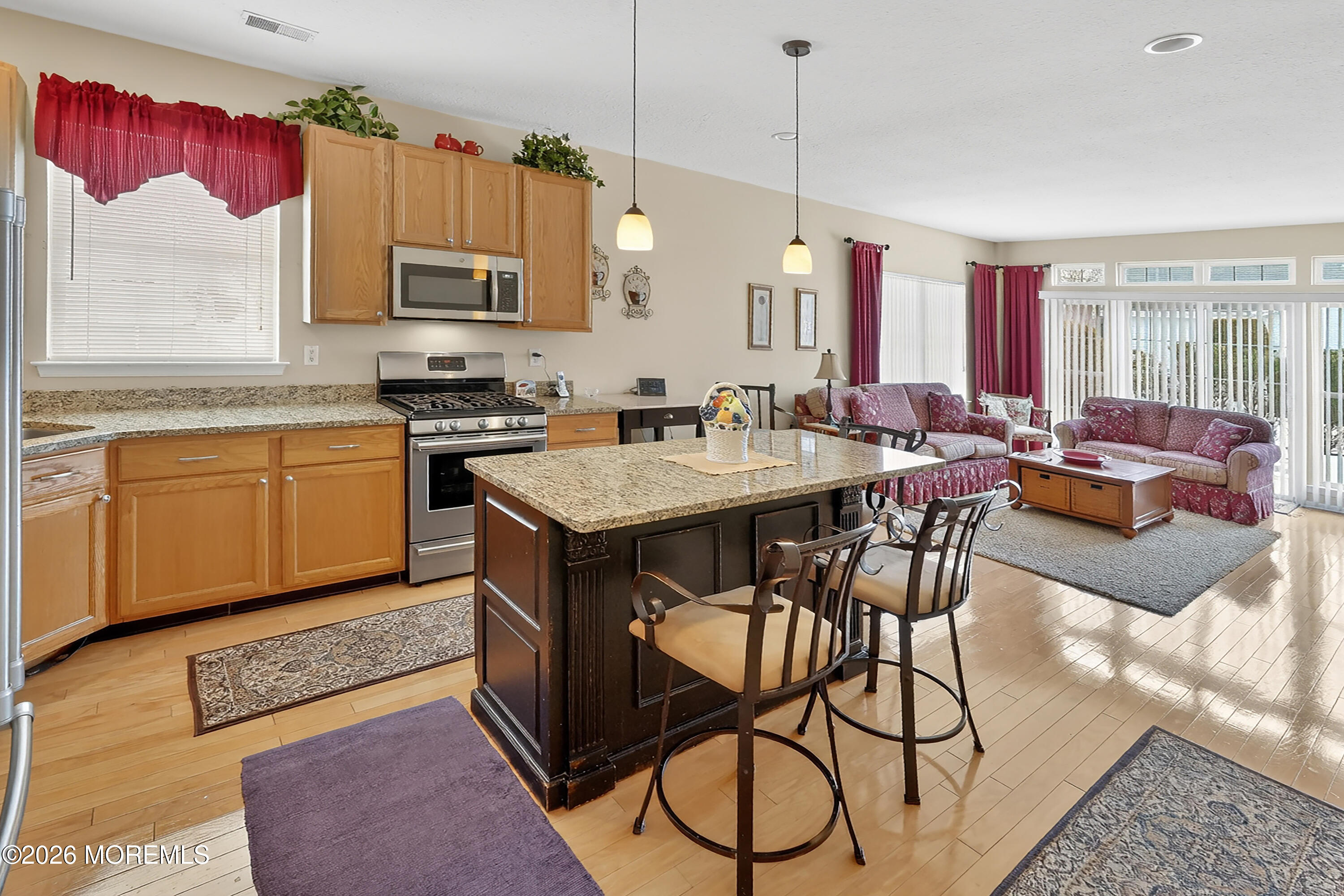 2526 Morningstar Road Manasquan, NJ 08736 - Photo 5 of 17 a kitchen with stainless steel appliances granite countertop a stove top oven a sink dishwasher and white cabinets with wooden floor
