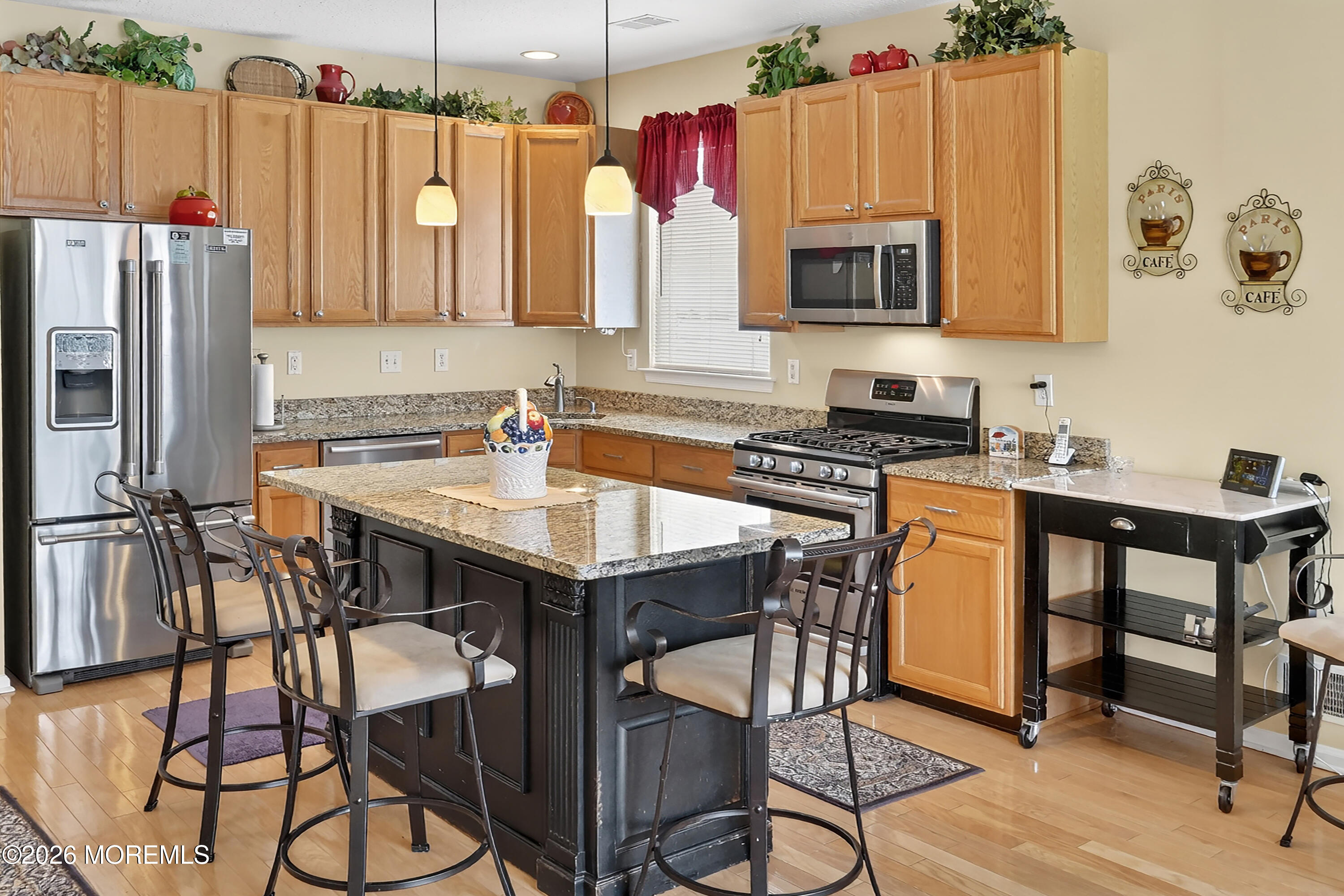 2526 Morningstar Road Manasquan, NJ 08736 - Photo 6 of 17 a kitchen with a table chairs refrigerator and microwave