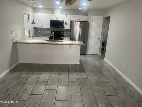 a kitchen with a sink and cabinets