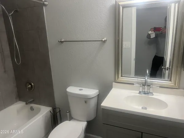 a white toilet sitting next to a bathroom sink