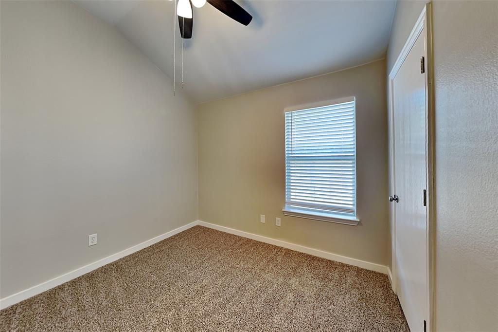 4920 Mountain Ridge Lane McKinney, TX 75071 - Photo 14 of 19 Empty room featuring carpet floors, vaulted ceiling, and ceiling fan