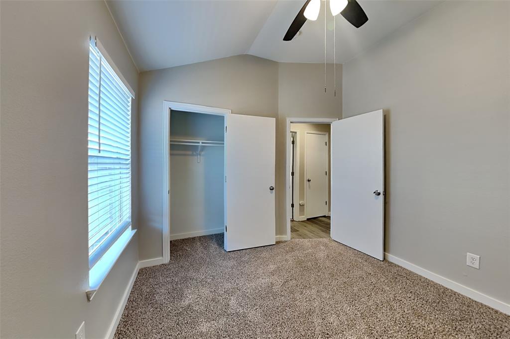 4920 Mountain Ridge Lane McKinney, TX 75071 - Photo 15 of 19 Unfurnished bedroom with light colored carpet, lofted ceiling, a closet, and a ceiling fan