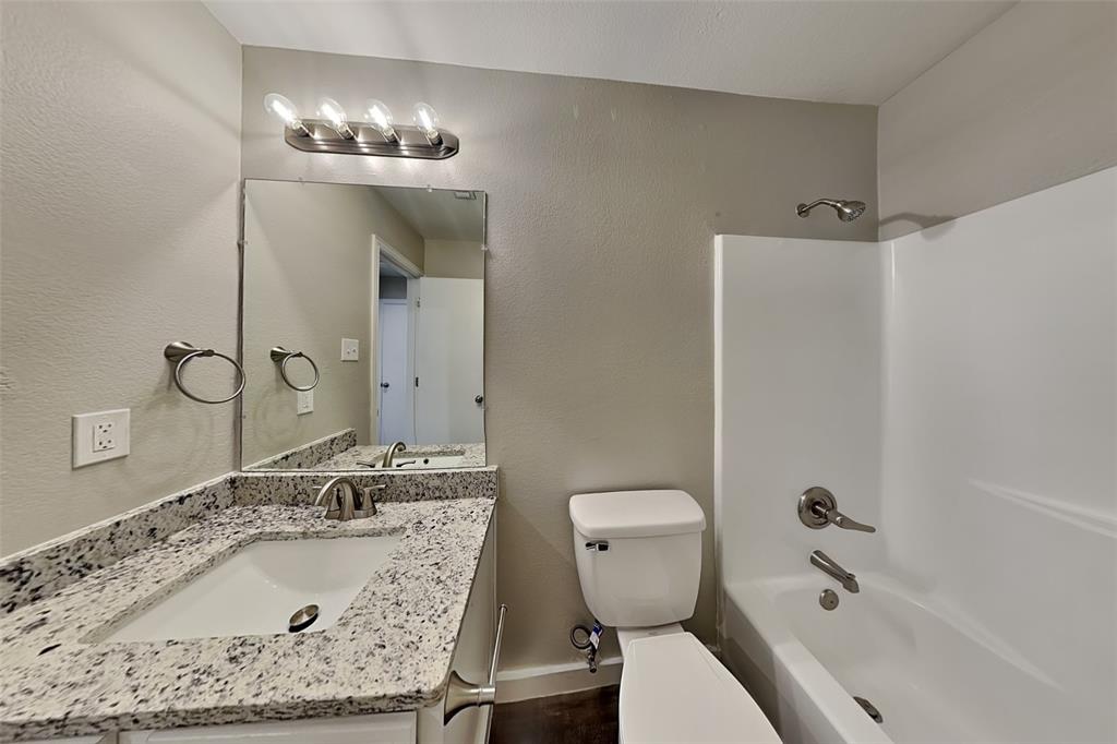 4920 Mountain Ridge Lane McKinney, TX 75071 - Photo 16 of 19 Full bath with a textured wall, shower / tub combination, and vanity