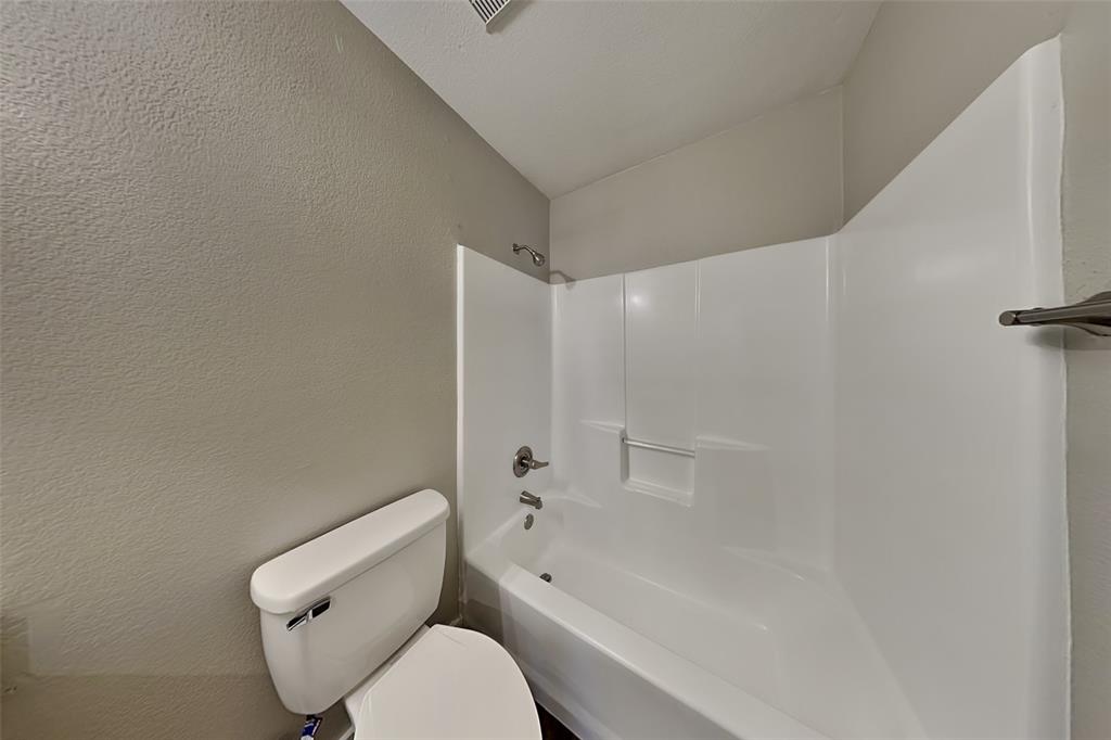 4920 Mountain Ridge Lane McKinney, TX 75071 - Photo 17 of 19 Full bath with a textured wall and bathtub / shower combination