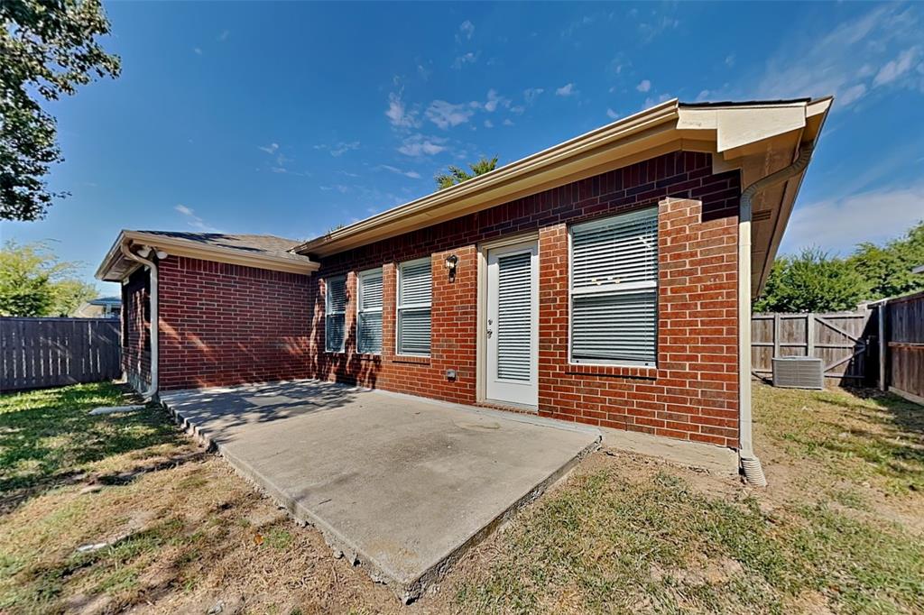 4920 Mountain Ridge Lane McKinney, TX 75071 - Photo 18 of 19 Rear view of property featuring a fenced backyard, brick siding, and a patio