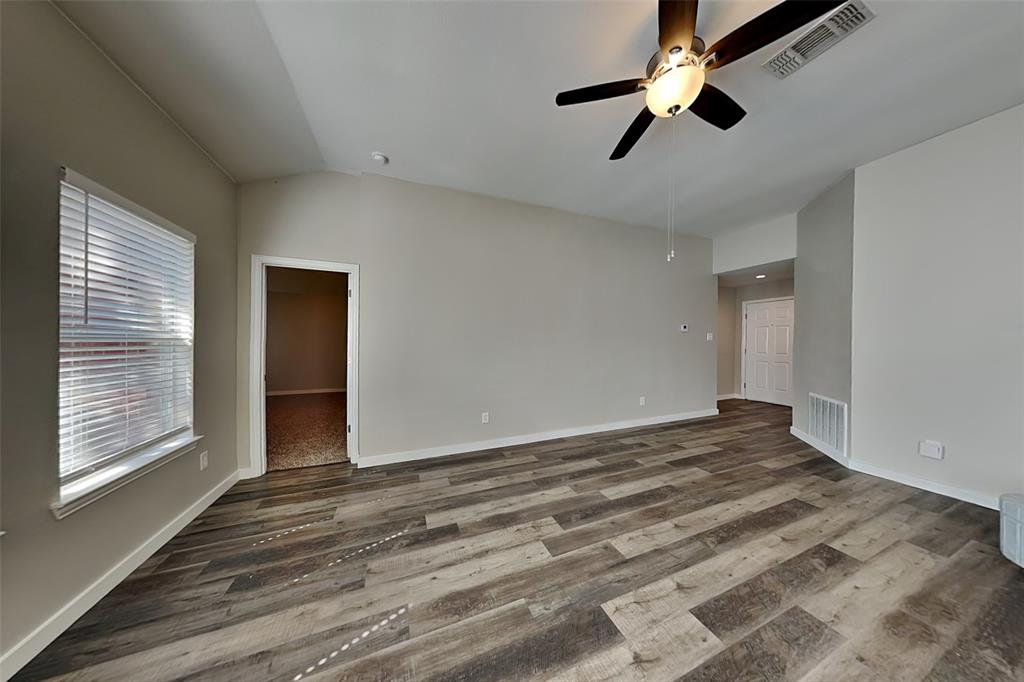 4920 Mountain Ridge Lane McKinney, TX 75071 - Photo 3 of 19 Spare room featuring lofted ceiling, light wood-type flooring, and a ceiling fan