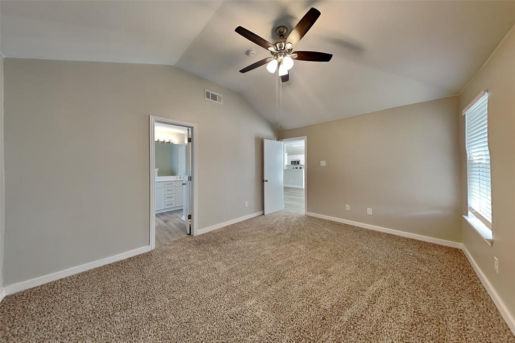 4920 Mountain Ridge Lane McKinney, TX 75071 - Photo 6 of 19 Unfurnished bedroom with lofted ceiling, carpet flooring, ceiling fan, and ensuite bathroom