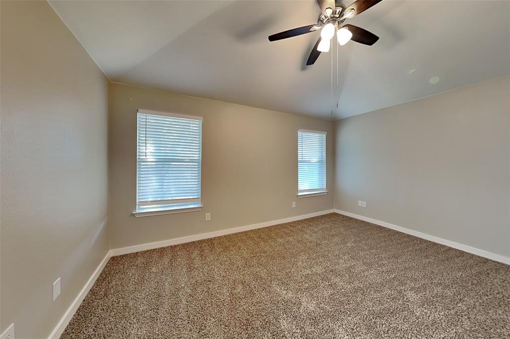 4920 Mountain Ridge Lane McKinney, TX 75071 - Photo 8 of 19 Carpeted empty room with ceiling fan and vaulted ceiling