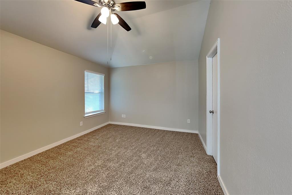 4920 Mountain Ridge Lane McKinney, TX 75071 - Photo 9 of 19 Unfurnished room featuring carpet flooring, vaulted ceiling, and a ceiling fan