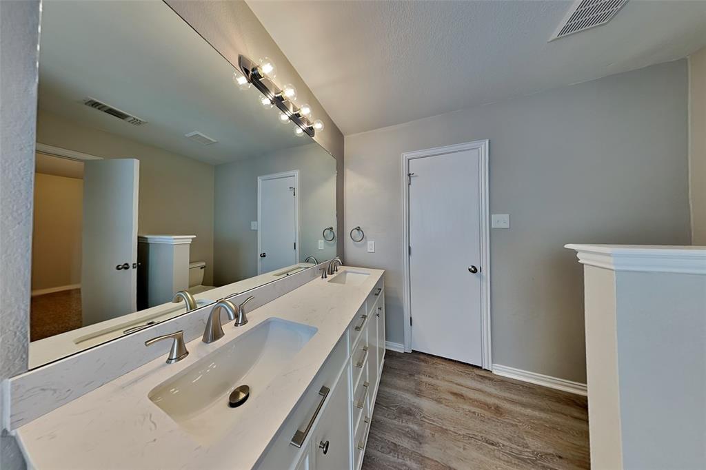 4920 Mountain Ridge Lane McKinney, TX 75071 - Photo 10 of 19 Bathroom featuring double vanity and light wood finished floors