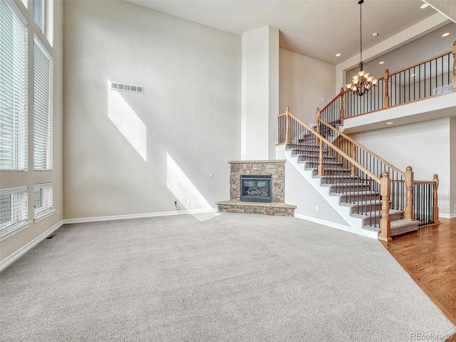 9741 Sunset Hill Circle Lone Tree, CO 80124 - Photo 13 of 43 a view of entryway and hall with wooden floor