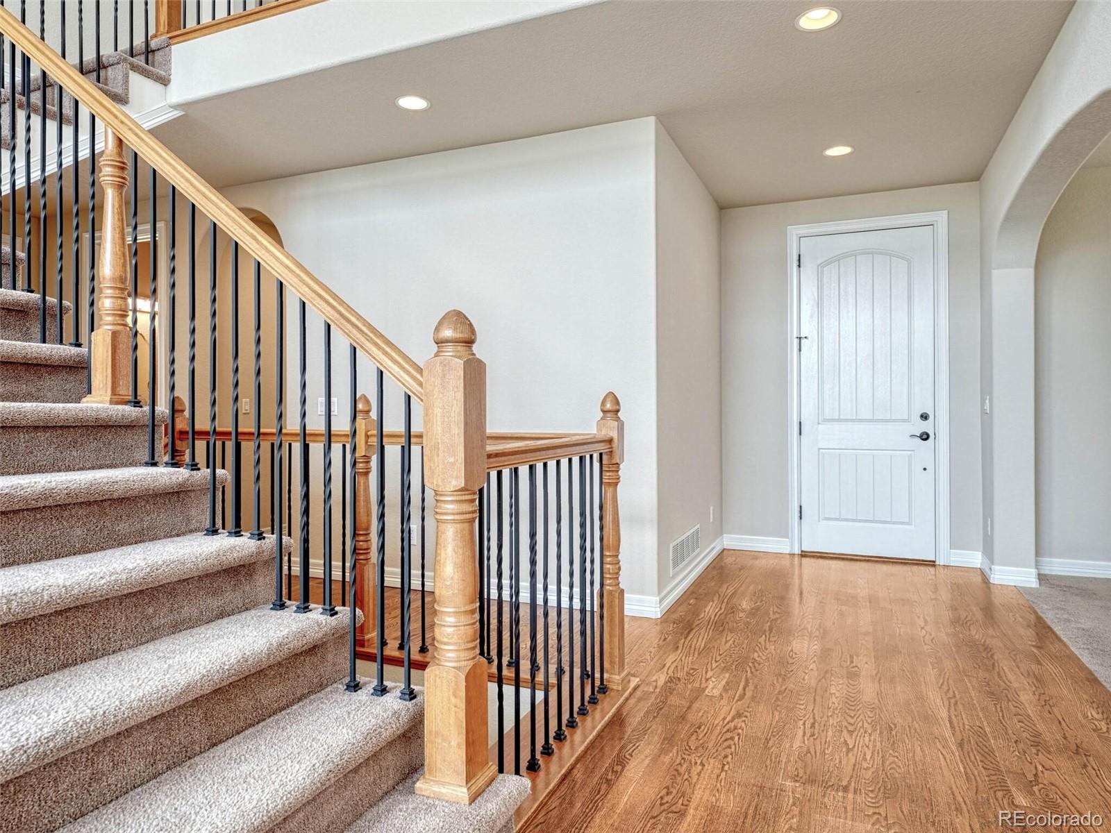 9741 Sunset Hill Circle Lone Tree, CO 80124 - Photo 15 of 43 a view of a hallway with wooden floor and entryway