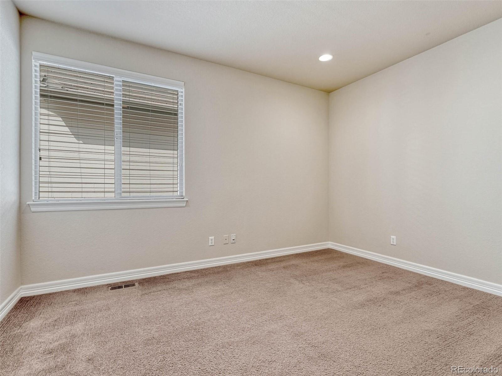 9741 Sunset Hill Circle Lone Tree, CO 80124 - Photo 18 of 43 an empty room with a window