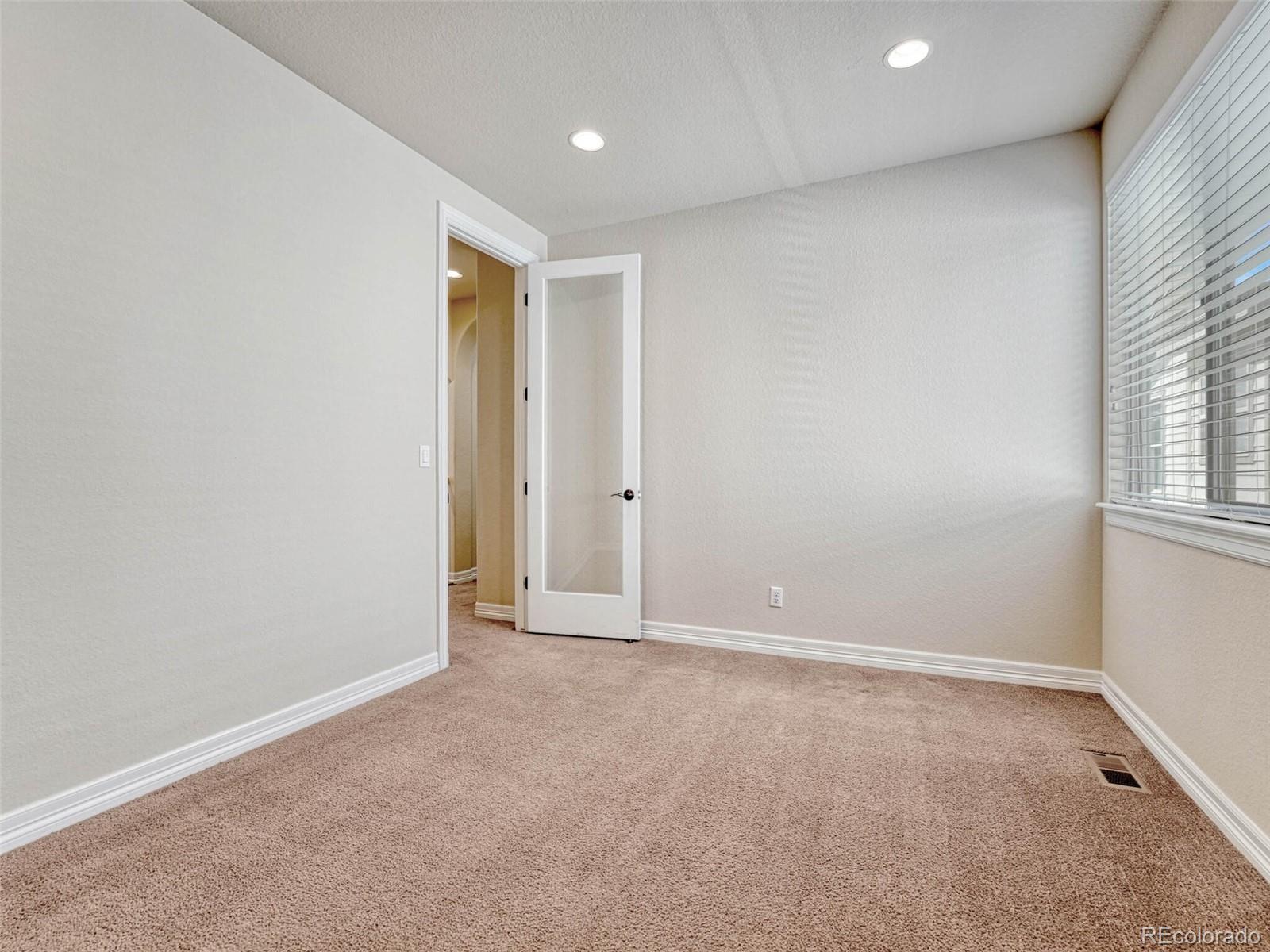 9741 Sunset Hill Circle Lone Tree, CO 80124 - Photo 19 of 43 an empty room with windows
