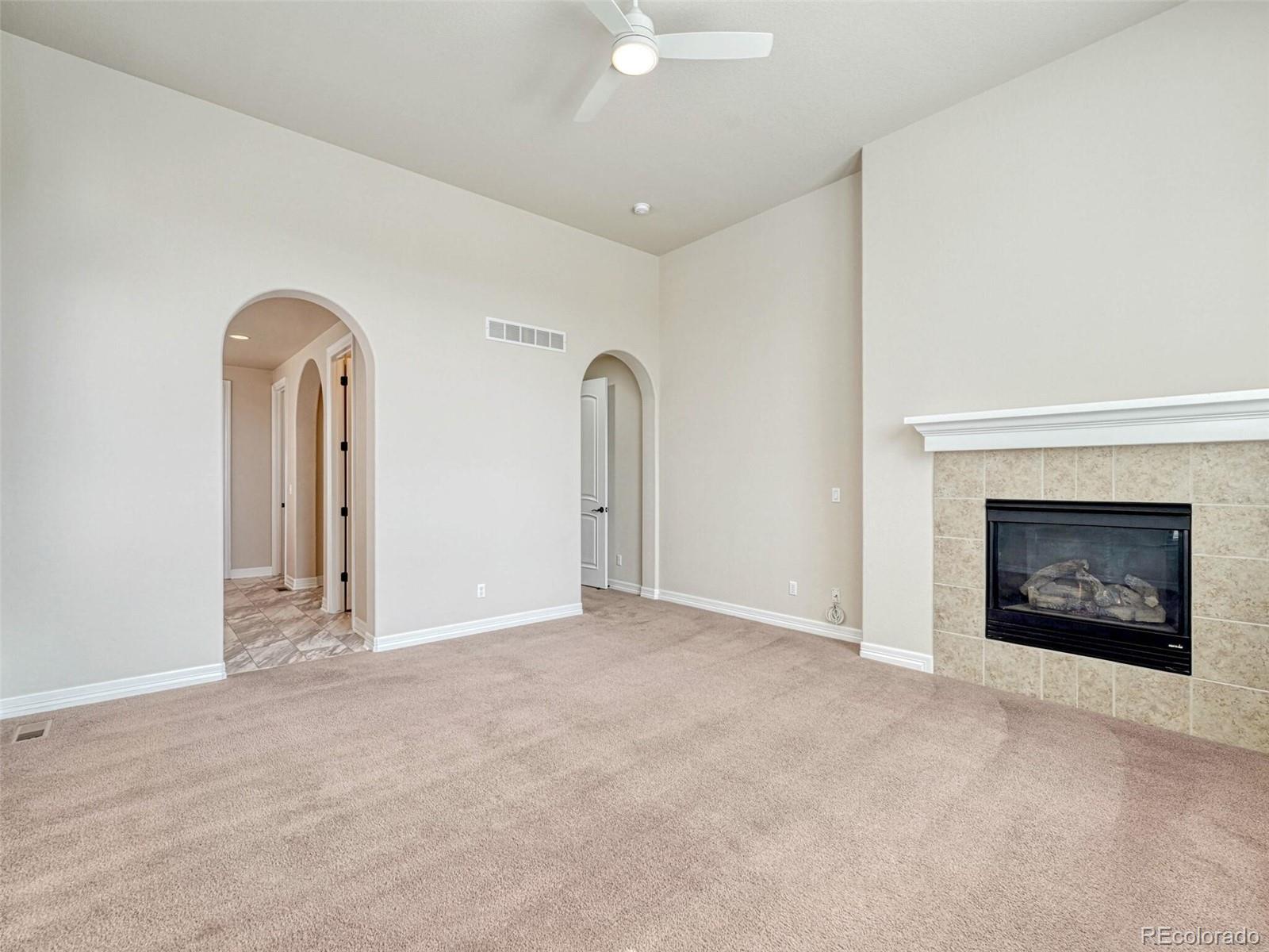 9741 Sunset Hill Circle Lone Tree, CO 80124 - Photo 22 of 43 a view of an empty room with a fireplace