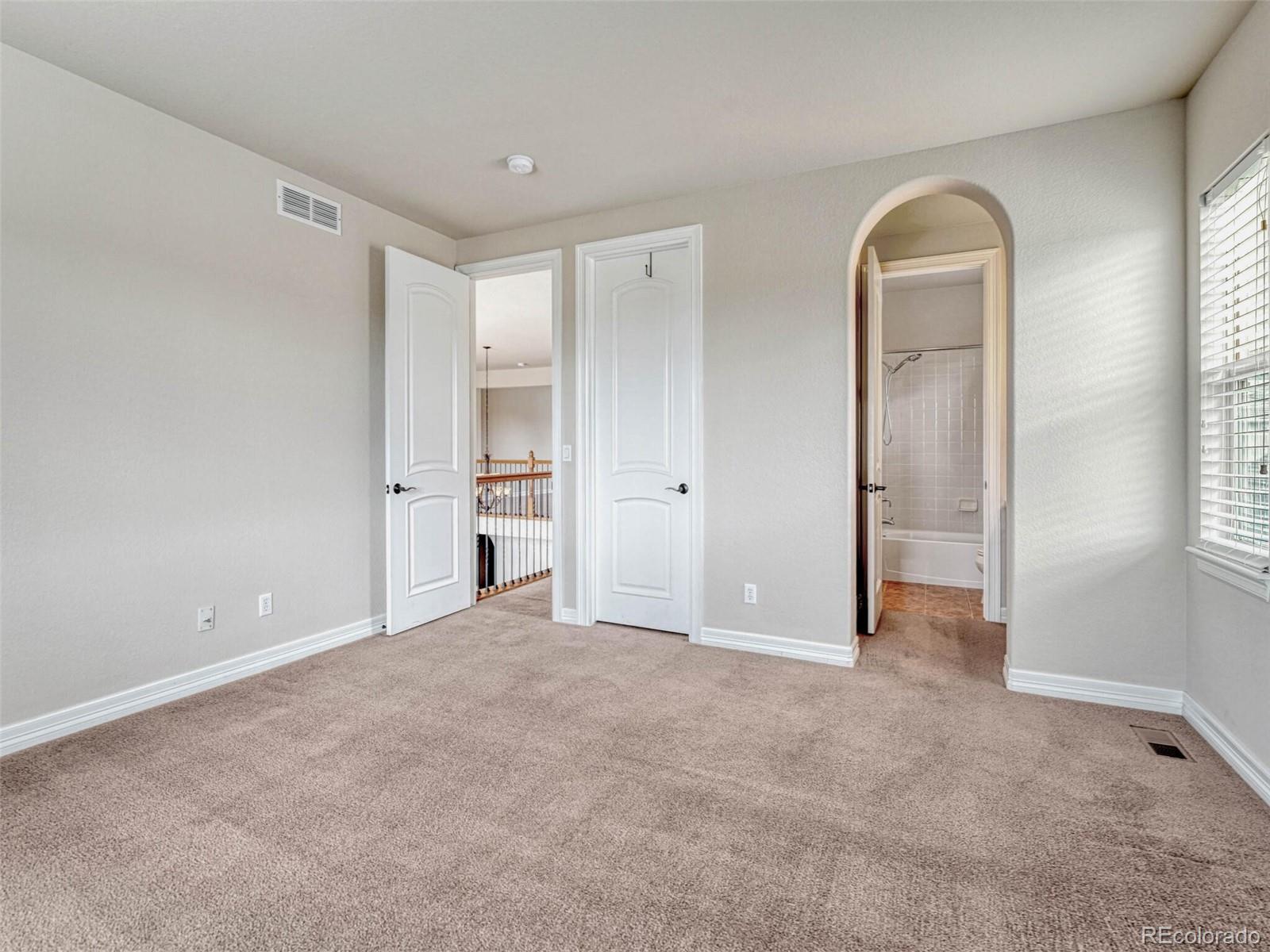 9741 Sunset Hill Circle Lone Tree, CO 80124 - Photo 34 of 43 a view of an empty room with window and cabinet