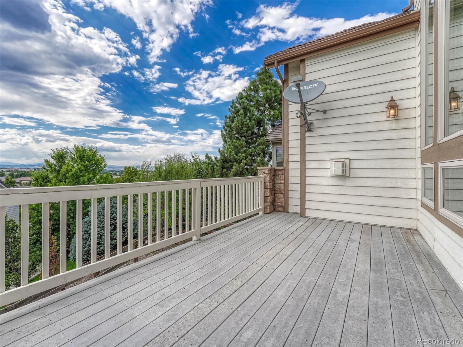 9741 Sunset Hill Circle Lone Tree, CO 80124 - Photo 35 of 43 a view of a balcony with wooden floor