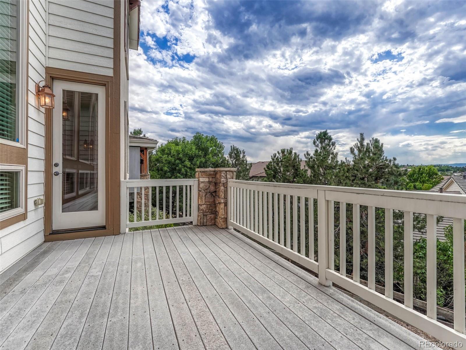 9741 Sunset Hill Circle Lone Tree, CO 80124 - Photo 36 of 43 a view of a wooden deck
