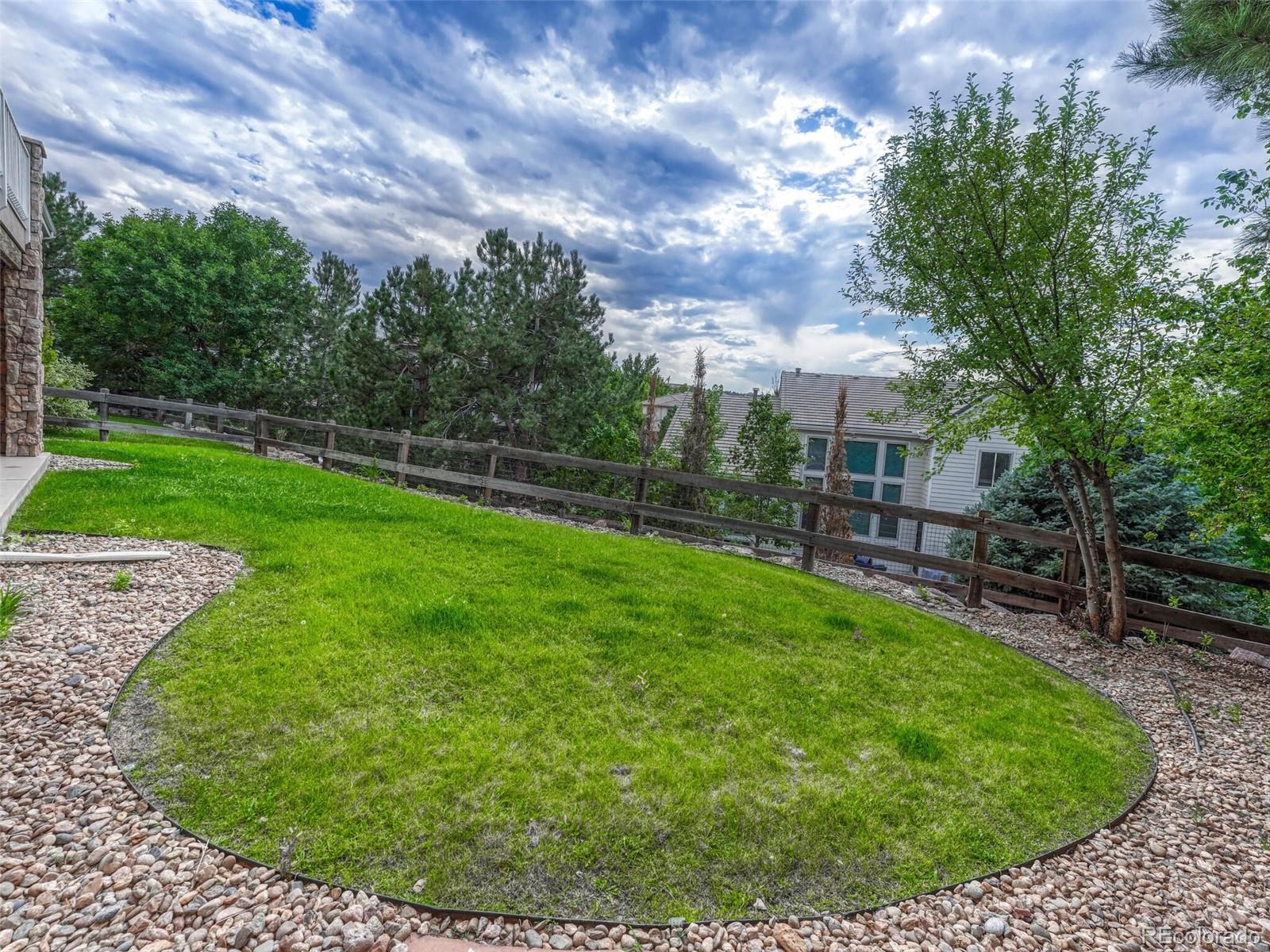 9741 Sunset Hill Circle Lone Tree, CO 80124 - Photo 37 of 43 a view of a backyard with a garden