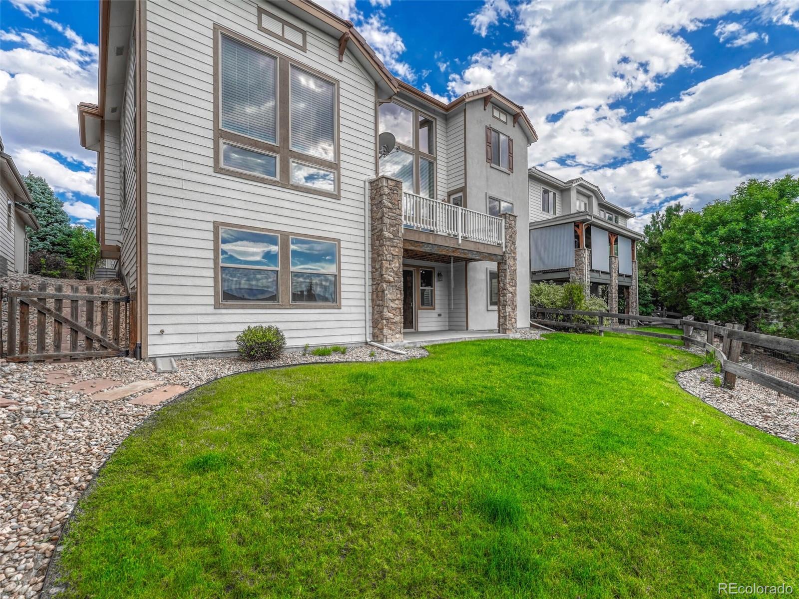 9741 Sunset Hill Circle Lone Tree, CO 80124 - Photo 38 of 43 a front view of a house with garden