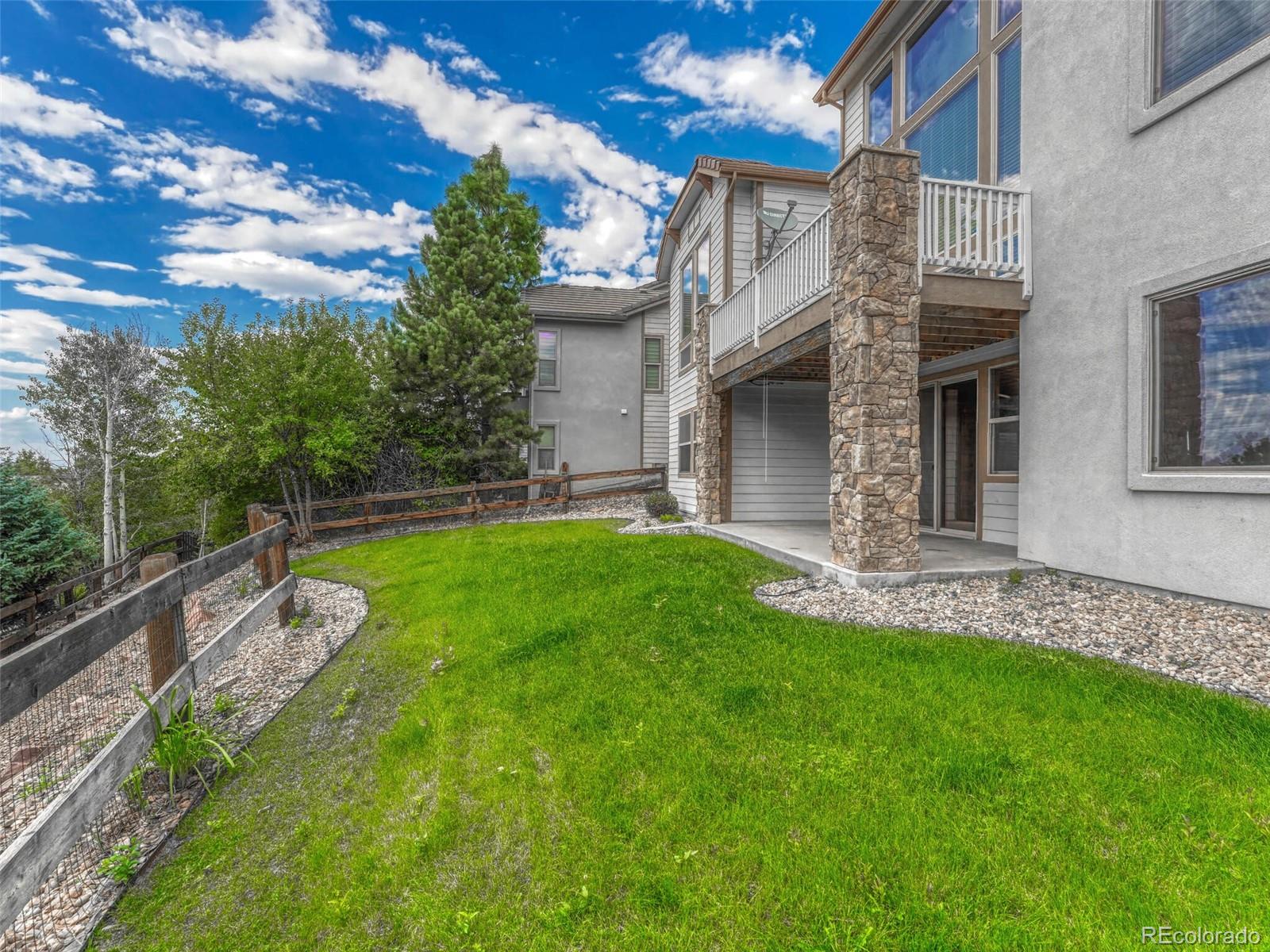 9741 Sunset Hill Circle Lone Tree, CO 80124 - Photo 39 of 43 a view of a house with a yard