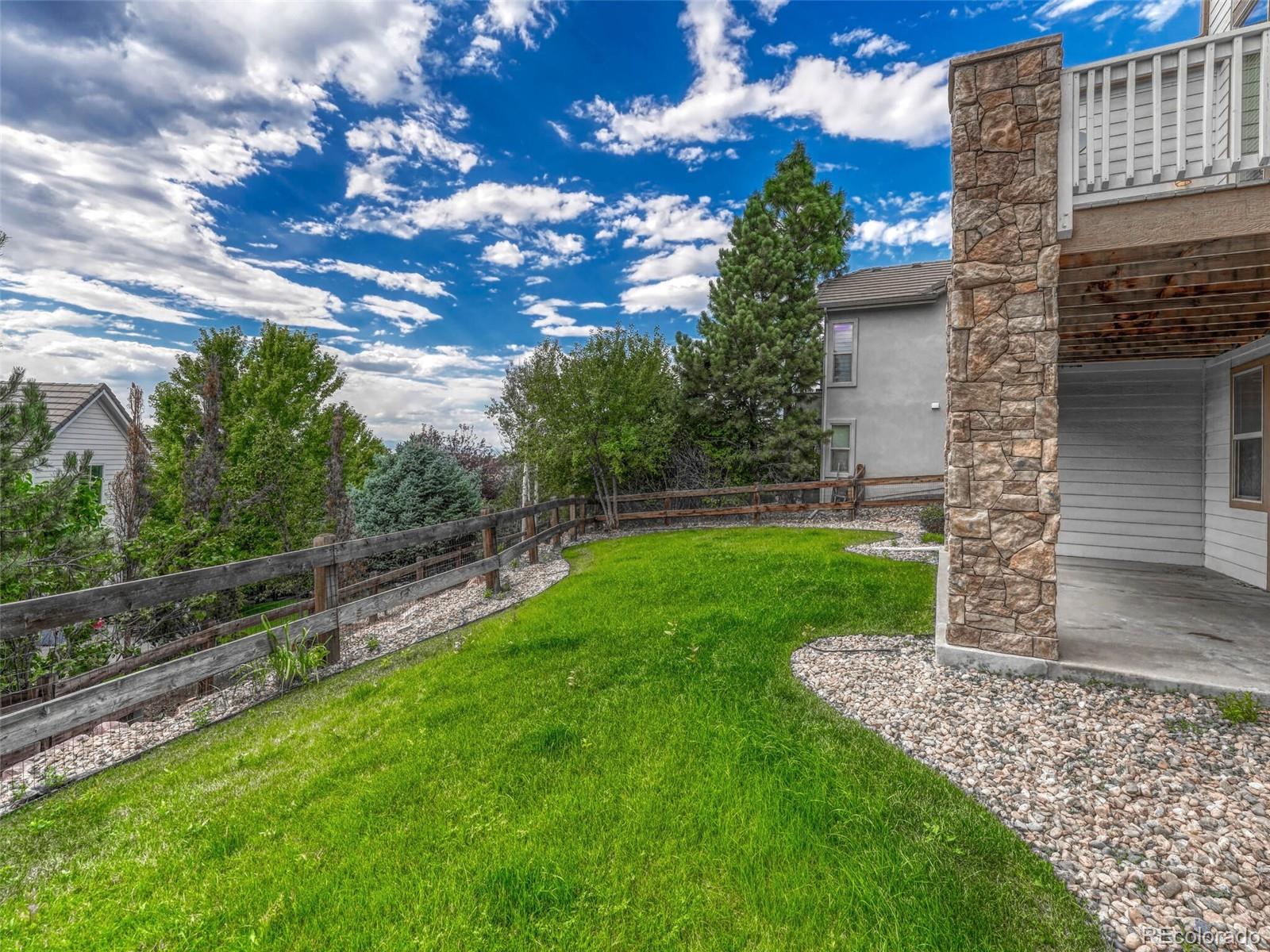 9741 Sunset Hill Circle Lone Tree, CO 80124 - Photo 40 of 43 a view of a backyard with a garden