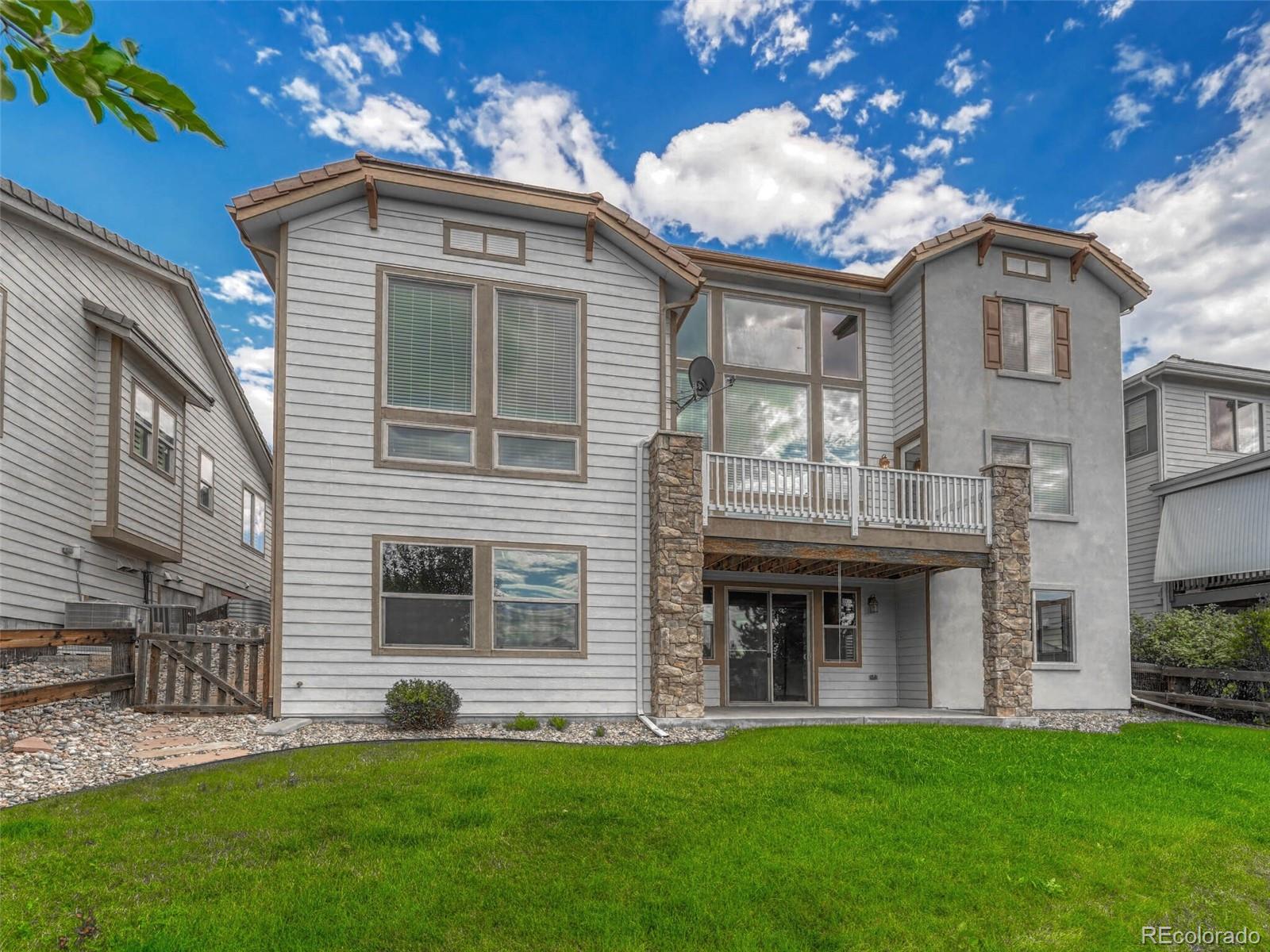 9741 Sunset Hill Circle Lone Tree, CO 80124 - Photo 41 of 43 a front view of a house with a garden and plants