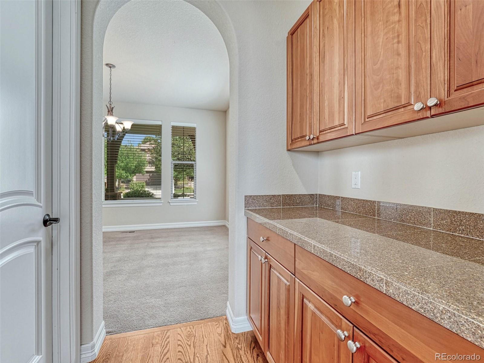 9741 Sunset Hill Circle Lone Tree, CO 80124 - Photo 6 of 43 a view of a kitchen cabinets and window