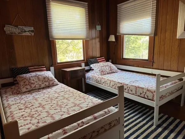 a bedroom with two beds and a window