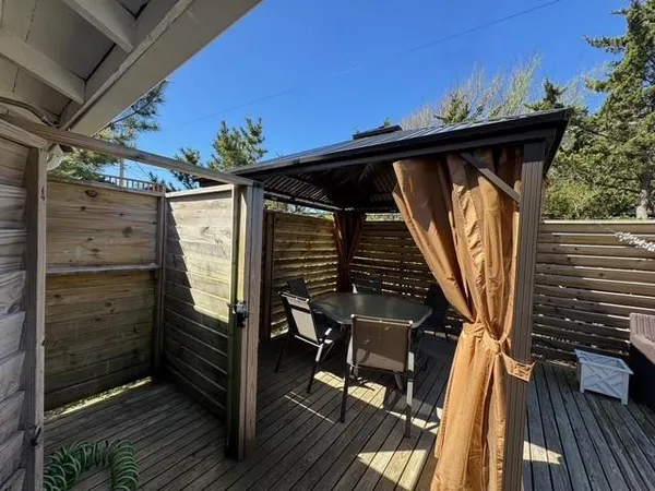a backyard of a house with table and chairs