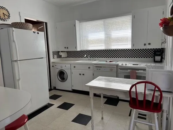 a kitchen with a refrigerator a stove a sink and a stove