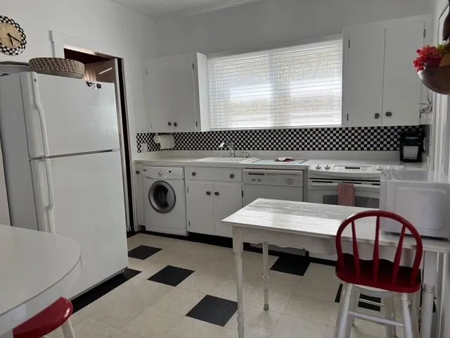 a kitchen with a refrigerator a stove a sink and a stove