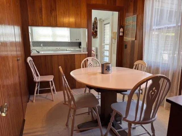a dining room with furniture and window