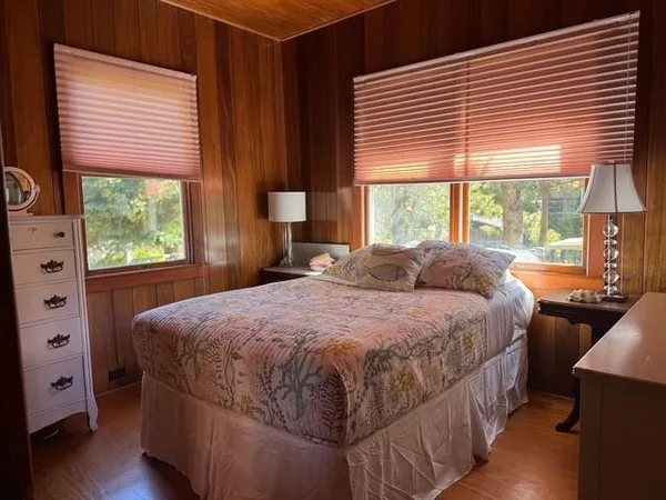 a bedroom with a bed and a large window