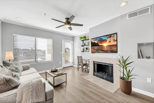 a living room with furniture a fireplace and a flat screen tv