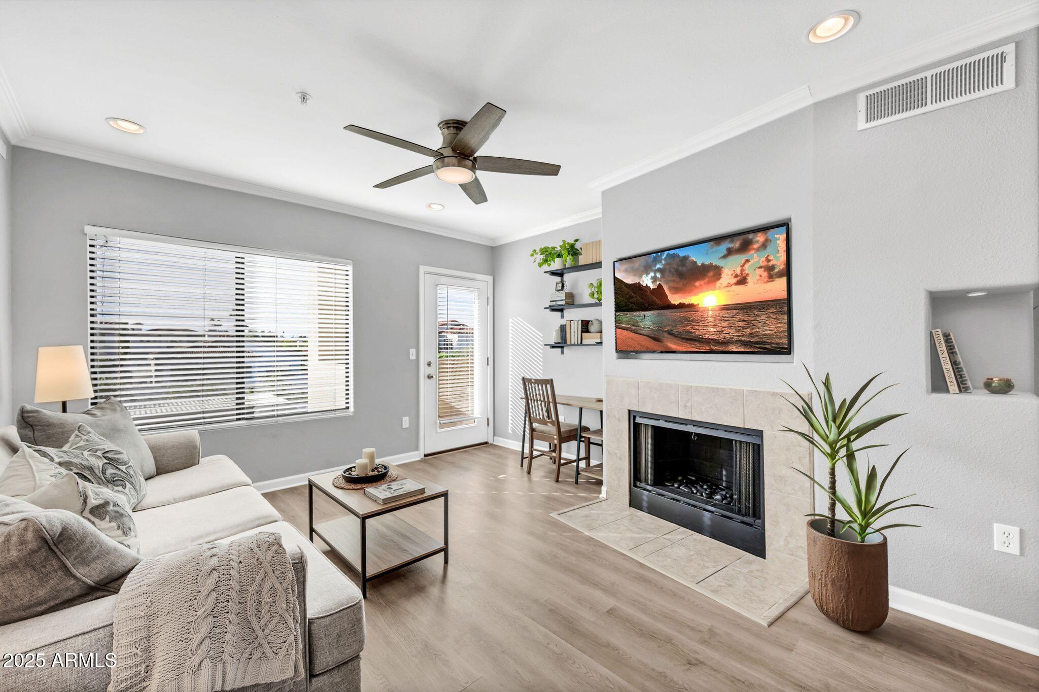 7575 East Indian Bend Road, Unit 2085 Scottsdale, AZ 85250 - Photo 1 of 30 a living room with furniture a fireplace and a flat screen tv