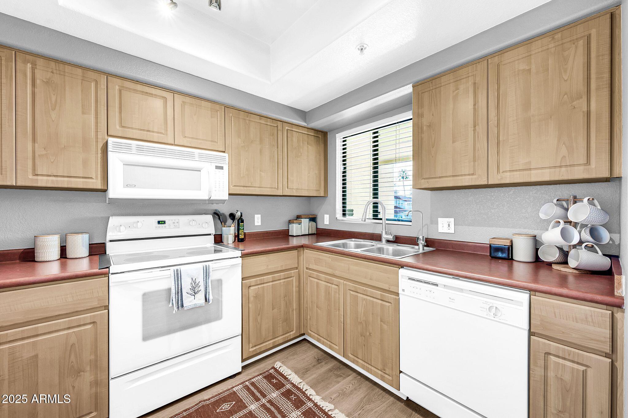 7575 East Indian Bend Road, Unit 2085 Scottsdale, AZ 85250 - Photo 10 of 30 a kitchen with a sink cabinets and window