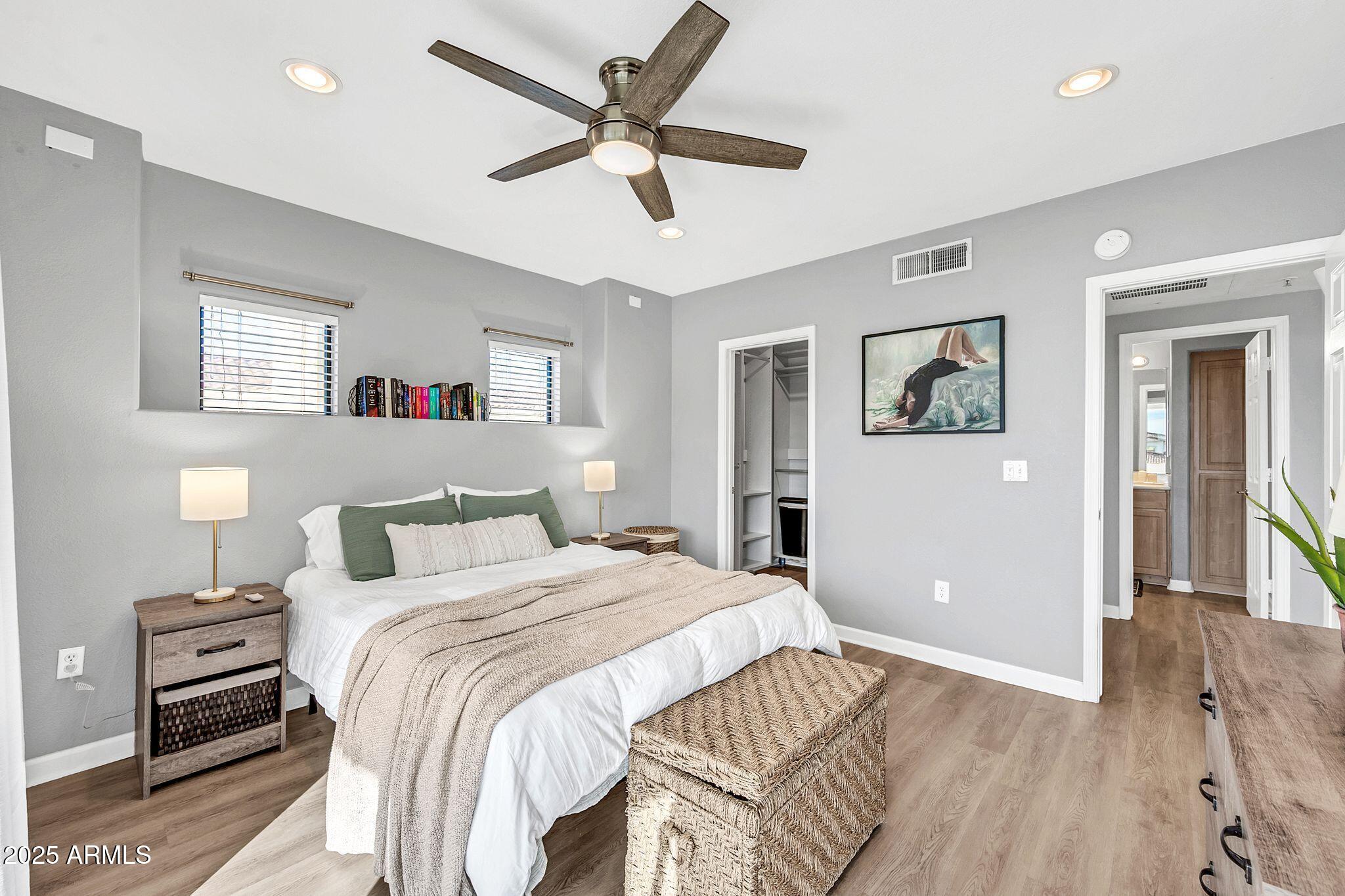 7575 East Indian Bend Road, Unit 2085 Scottsdale, AZ 85250 - Photo 12 of 30 a bedroom with a large bed and a chandelier