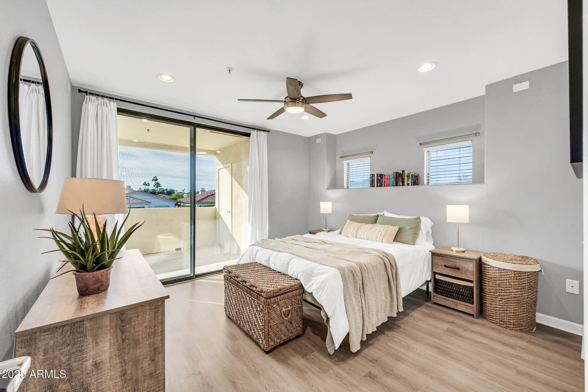 7575 East Indian Bend Road, Unit 2085 Scottsdale, AZ 85250 - Photo 13 of 30 a bedroom with a large bed and a chandelier