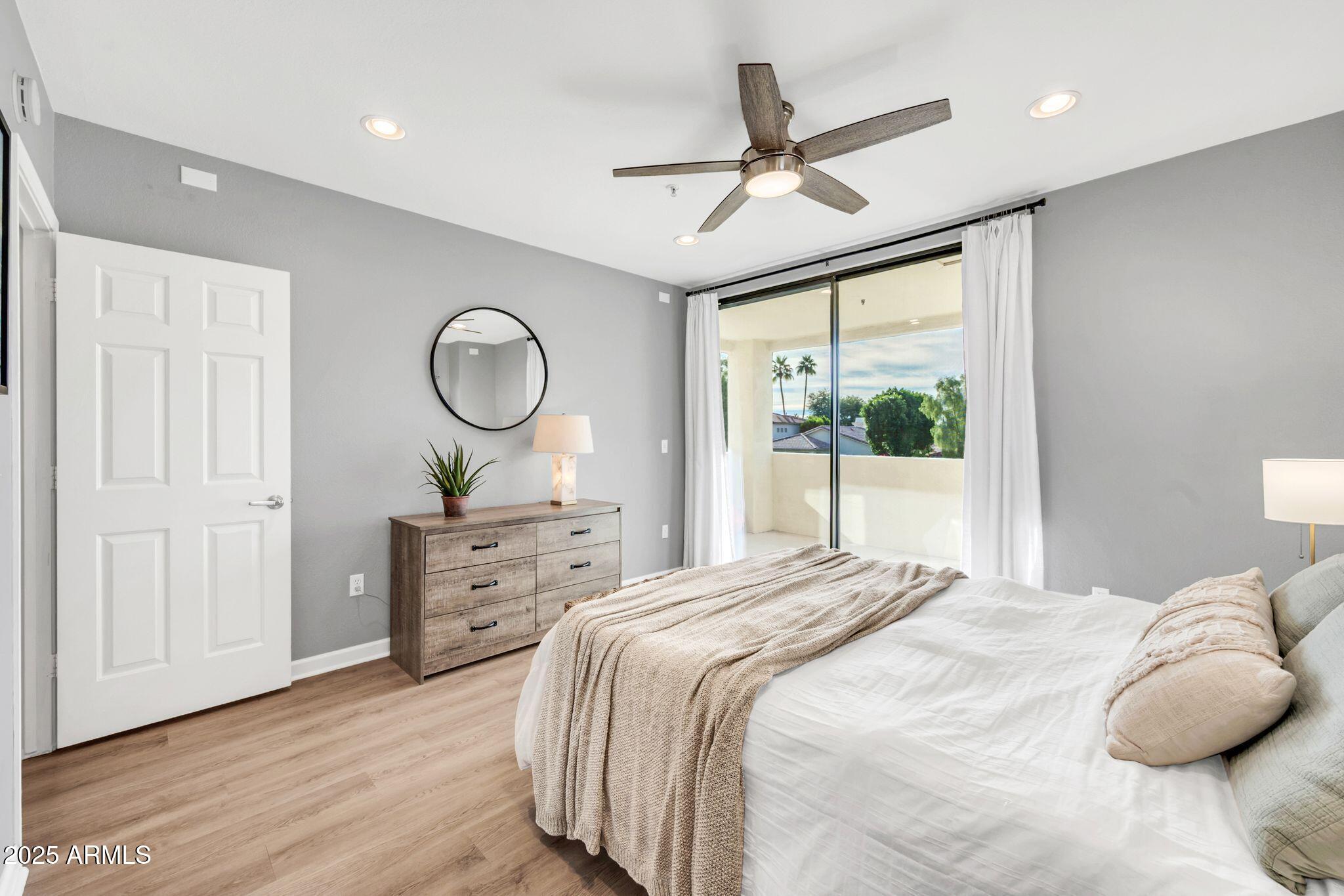 7575 East Indian Bend Road, Unit 2085 Scottsdale, AZ 85250 - Photo 14 of 30 a bedroom with a bed and a chandelier